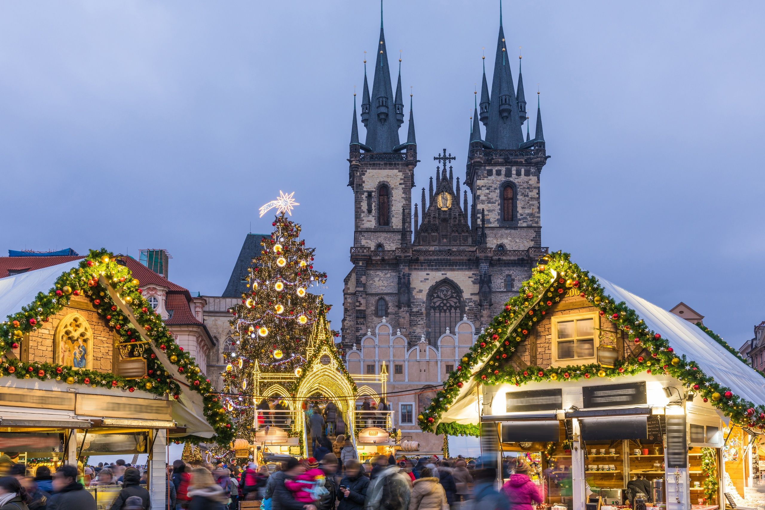 Prague Christmas market on the night in Old Town Square with blurred people on the move. Prague, Czech Republic. 